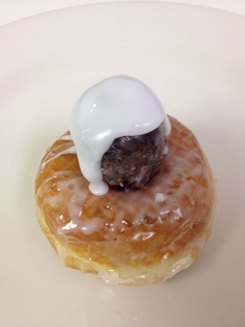 Pikes-Peak-donut.-It-is-a-glazed-chocolate-crueller-with-two-donut-balls-and-extra-icing